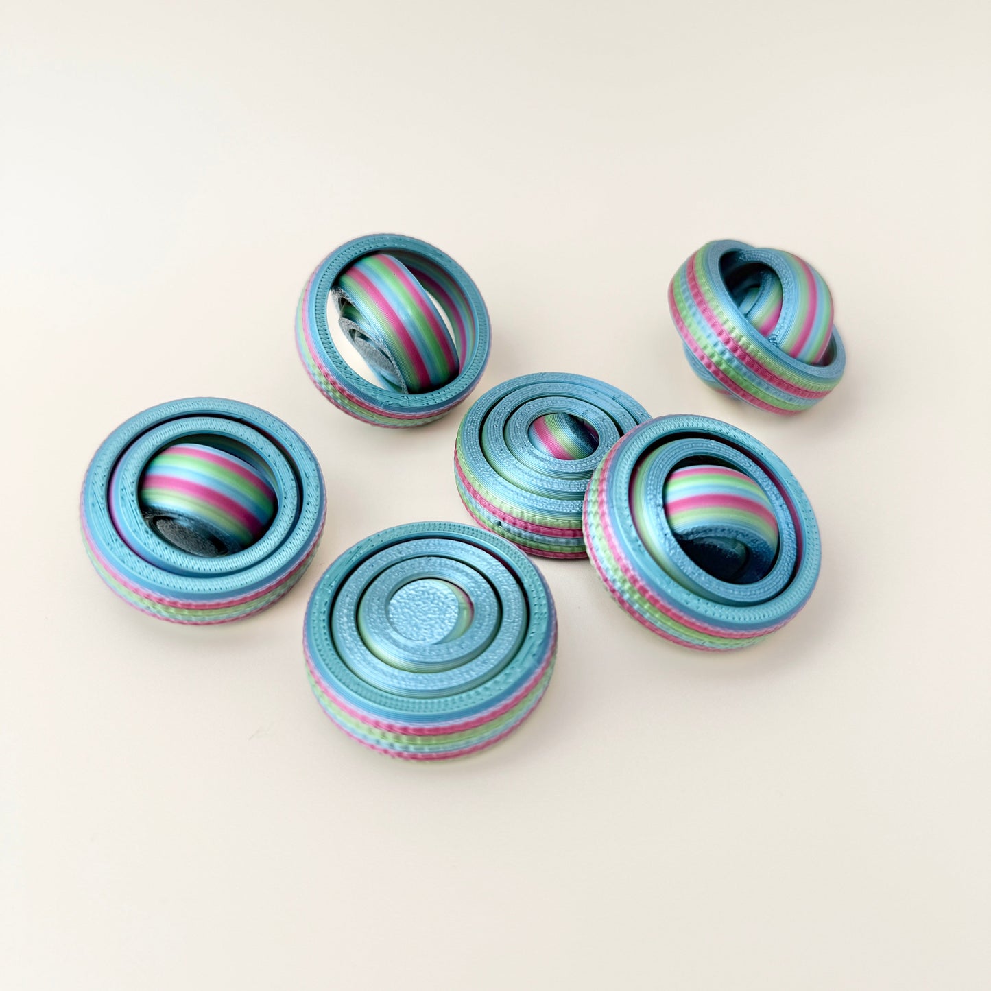 Smaller rainbow fidget spinner with textured edges for a secure grip, ideal for children.