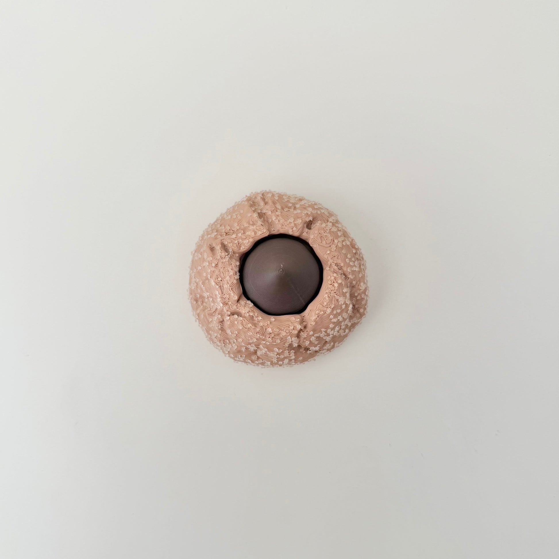 A compact clicker fidget with heavy texture and a press mechanism for focus and calming sensory use.
