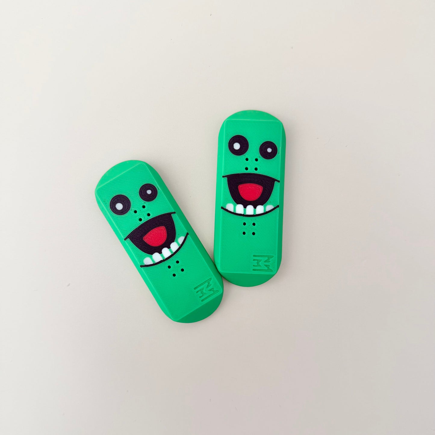 Green magnetic pickle fidget with bumpy surface for thumb tracing and grounding.
