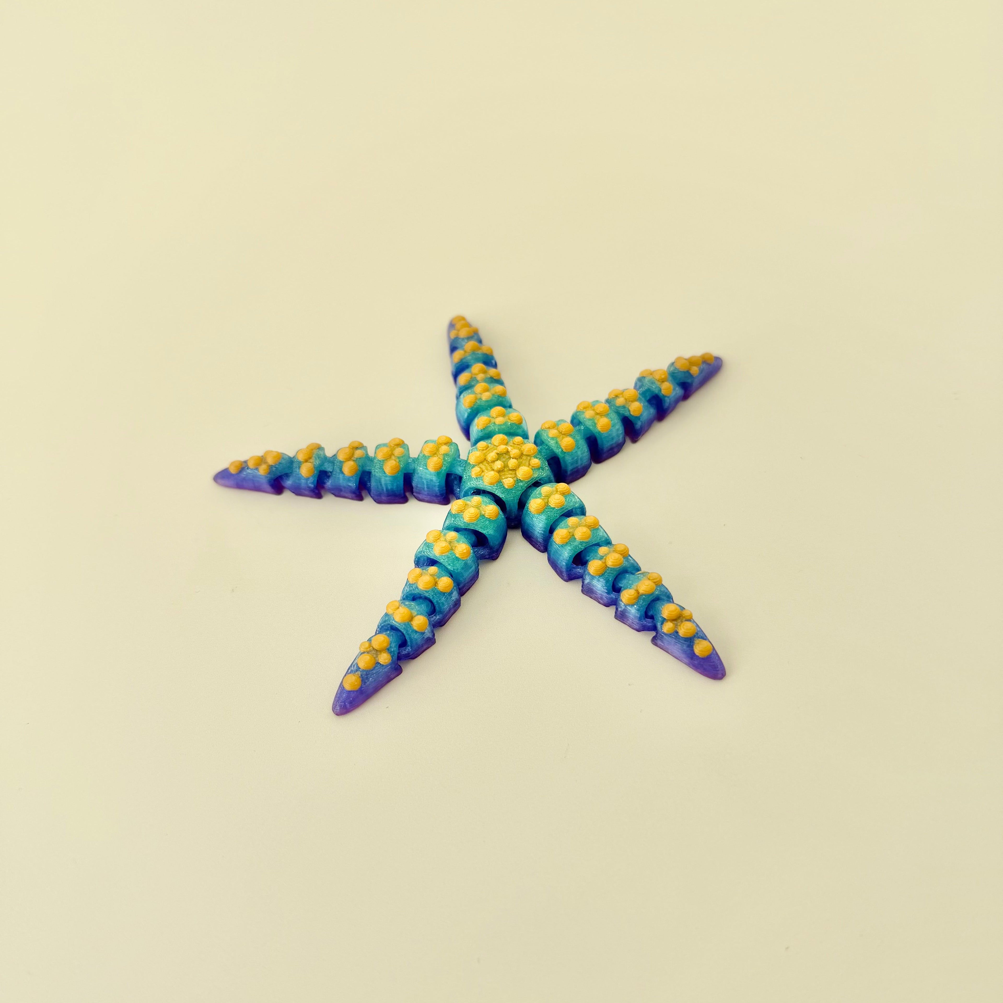 A flexible starfish toy offering gentle movement, subtle texture, and calming tactile input.
