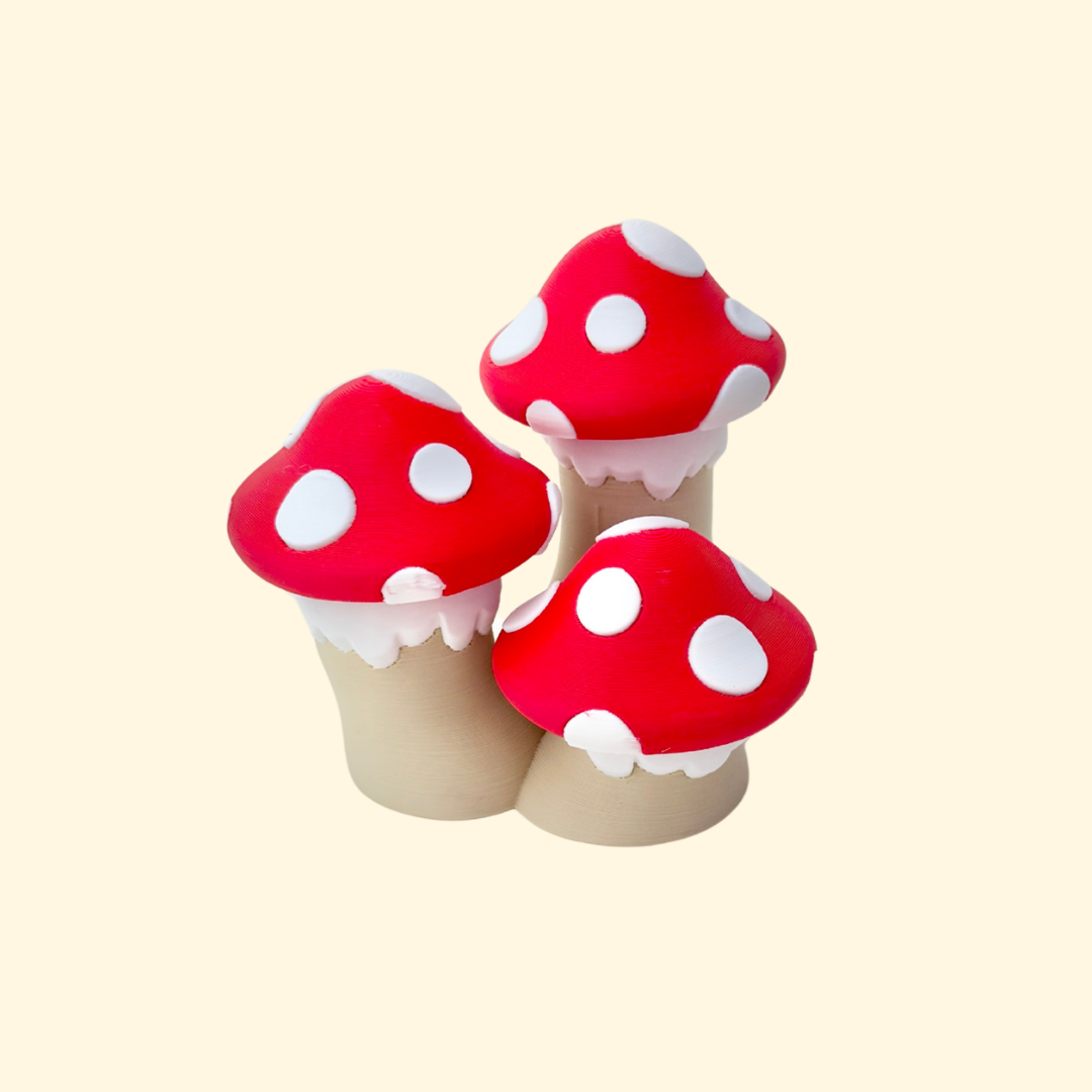 Cluster of three red-and-white mushroom caps that each press to click.
