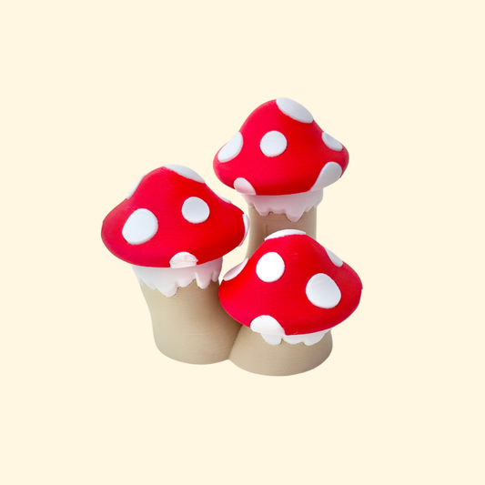 Cluster of three red-and-white mushroom caps that each press to click.

