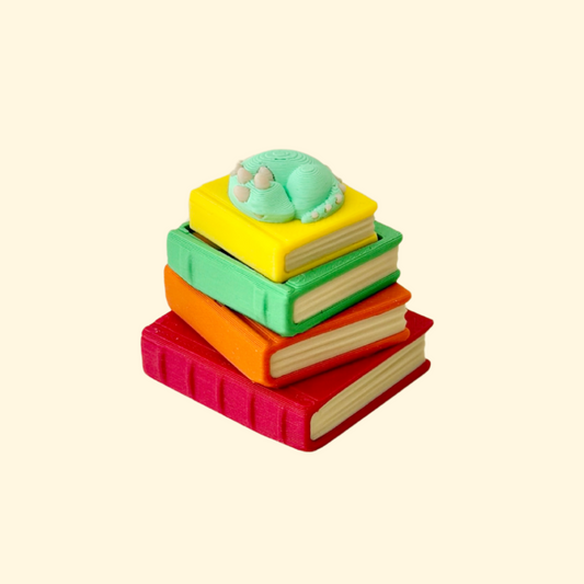 Compact 4 cm stack where the top book presses down for a satisfying click.
