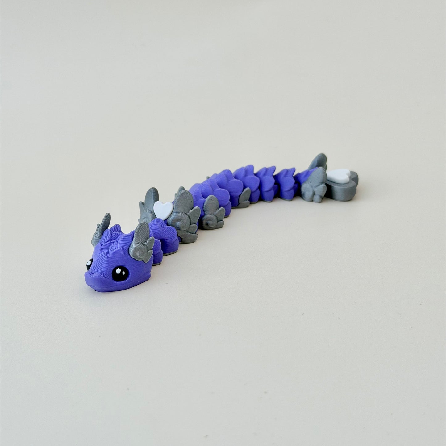 Durable PLA fidget with raised outlines for tracing and a satisfying press; supportive for neurodivergent users.