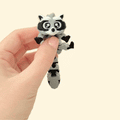 Fully articulated raccoon fidget toy with a grey trash can and lid for interactive play and sensory fun.