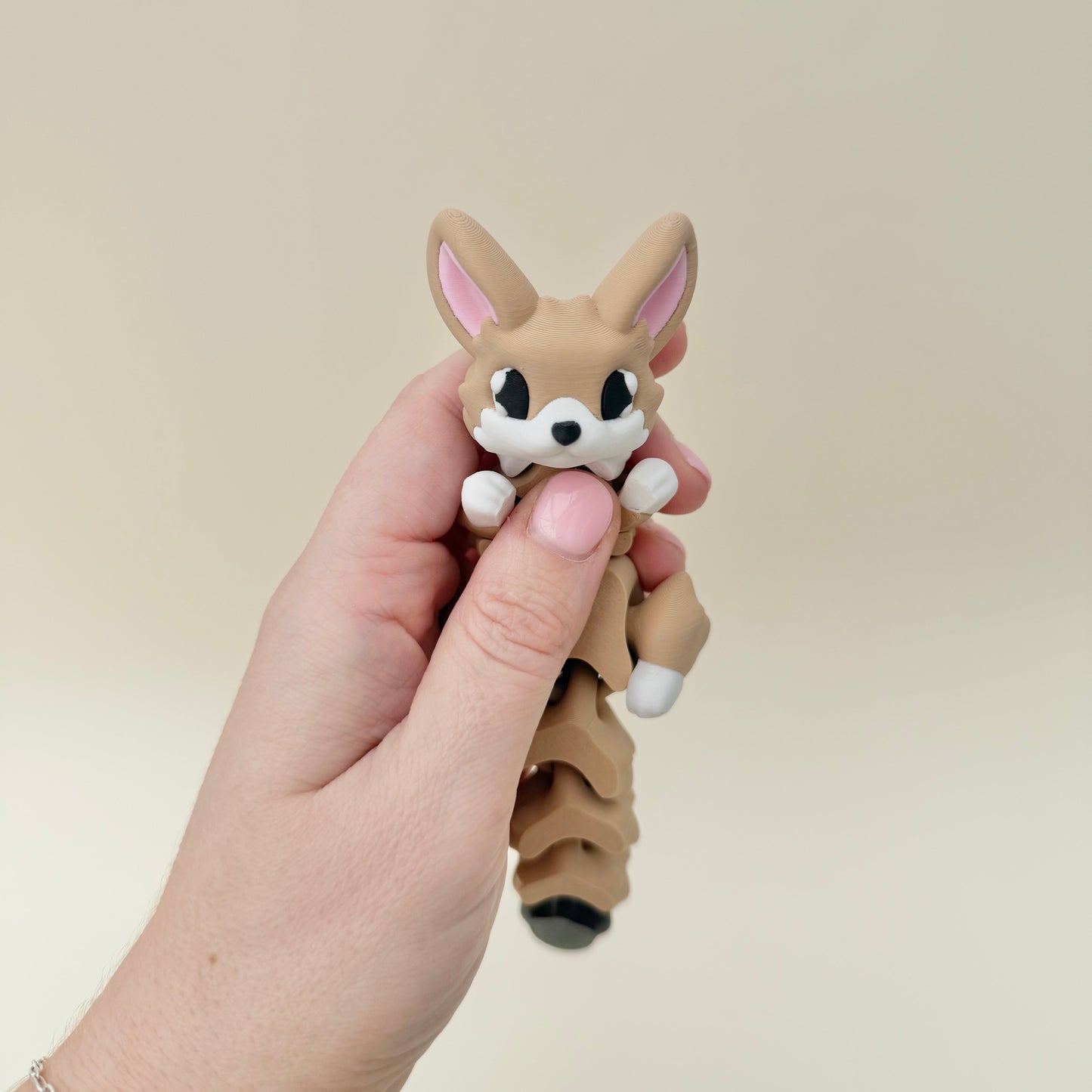 A portable fox fidget with smooth articulation, ideal as a sensory companion for journeys.

