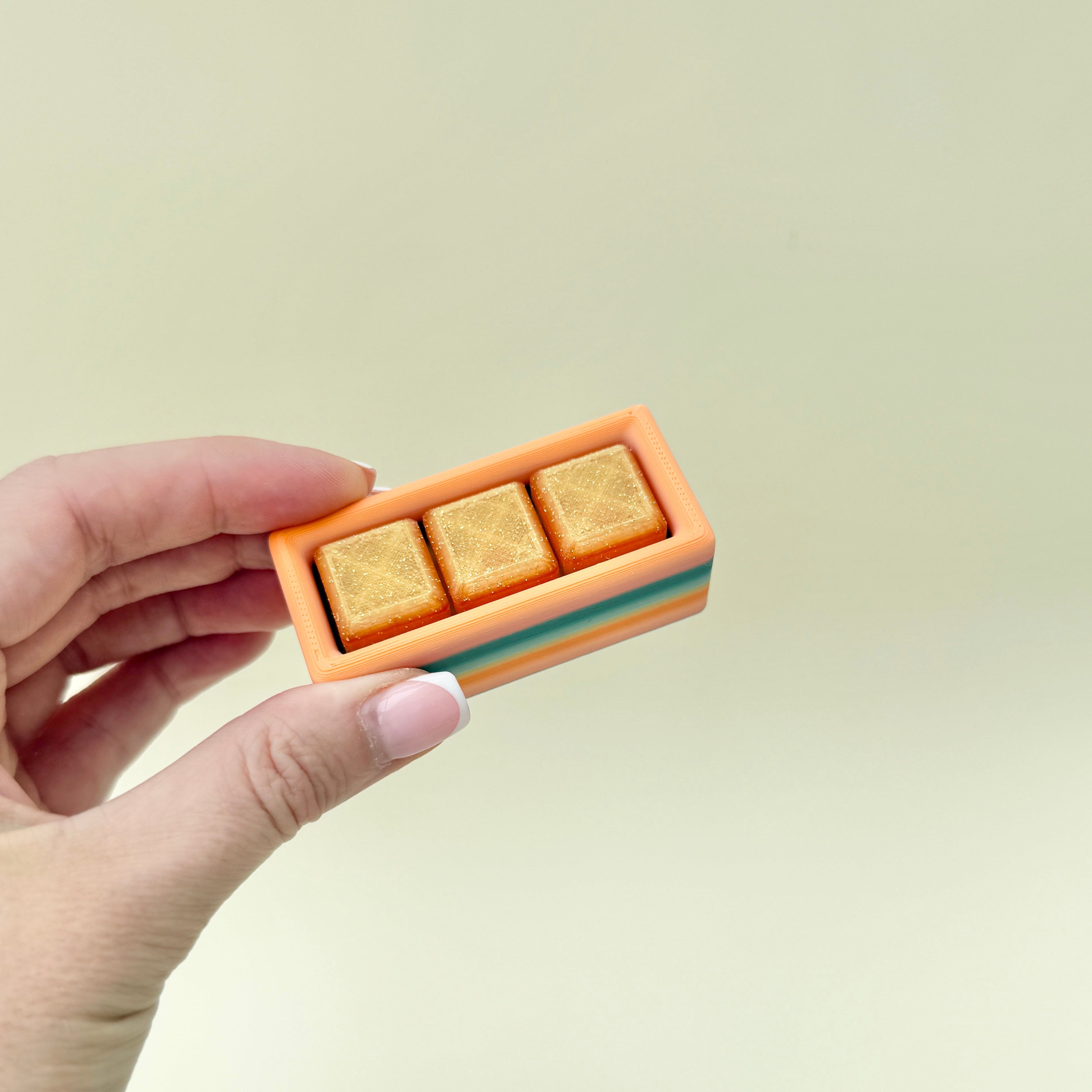 Portable rectangular fidget with three clickable buttons for on-the-go stress relief
