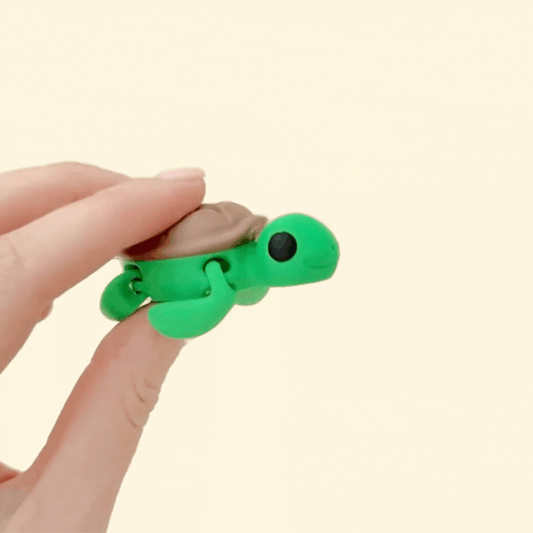 A fully articulated turtle fidget toy with a smooth gradient finish, designed for sensory play and stress relief.