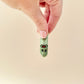 A creative fidget toy shaped like a bitten pickle, perfect for sensory play and gifts