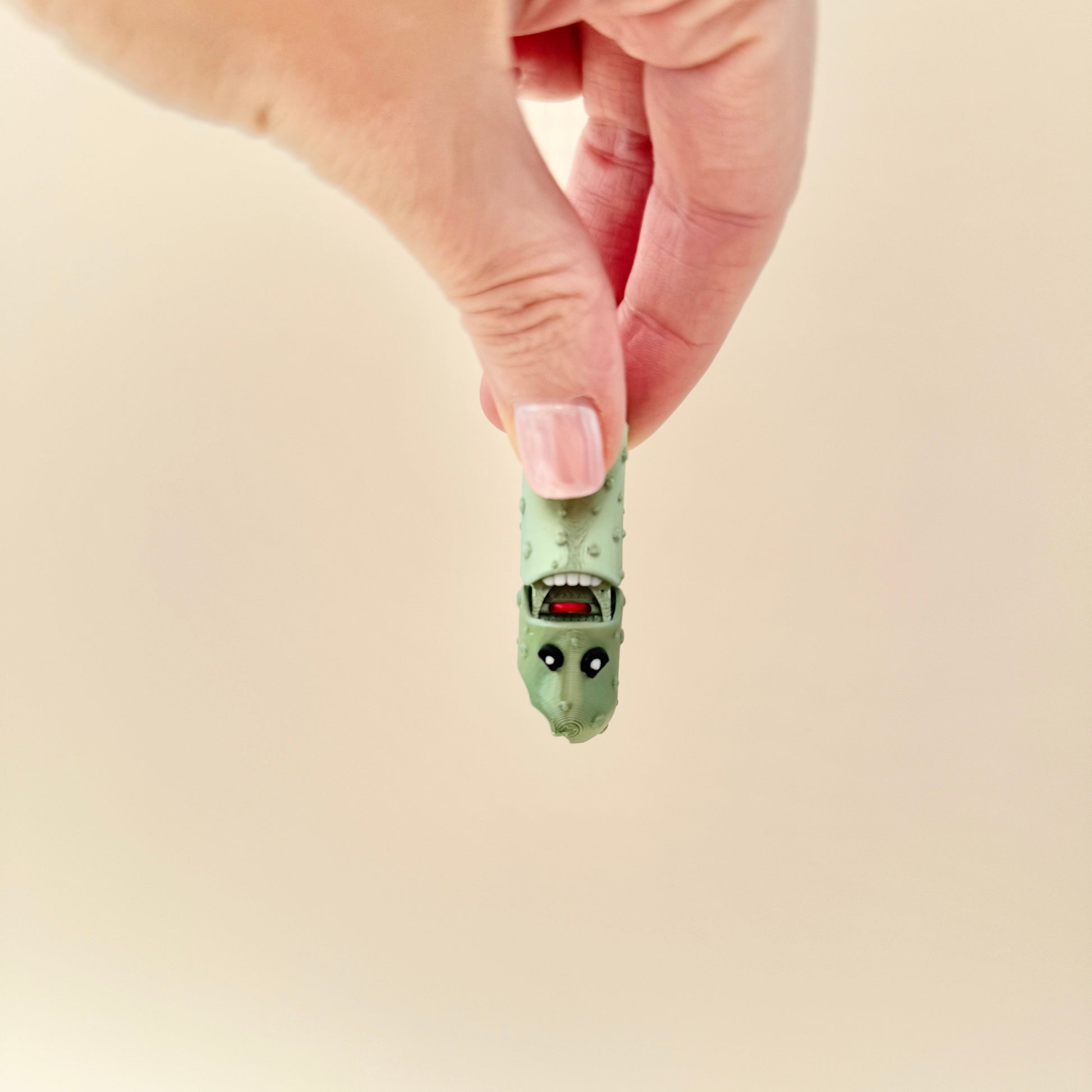 A creative fidget toy shaped like a bitten pickle, perfect for sensory play and gifts