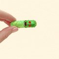 Green and gold colour-changing pickle fidget toy with red heart eyes, perfect for Valentine’s Day.
