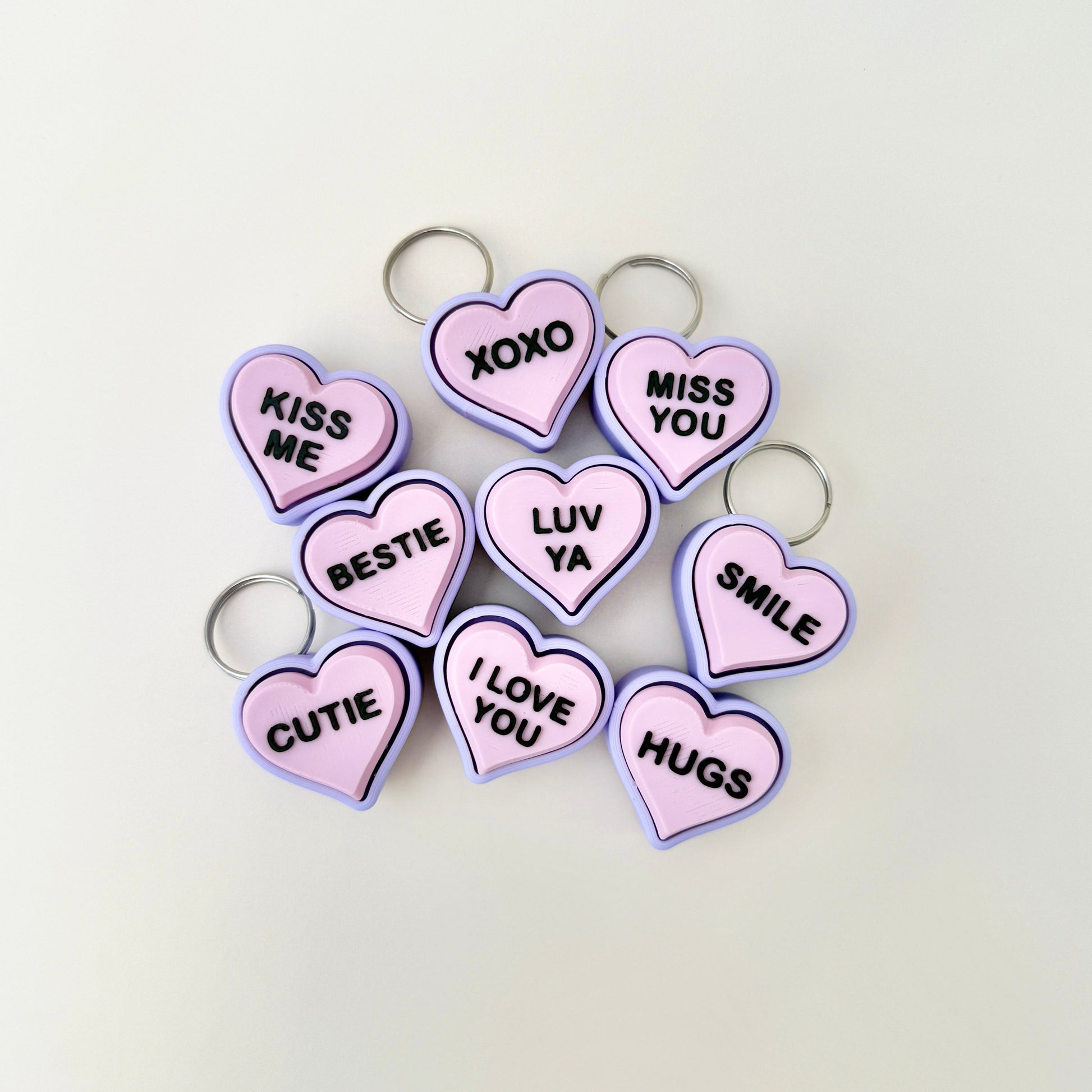 Portable heart-shaped clicker keyring with lilac and pink tones, ideal as a Valentine’s or friendship gift.