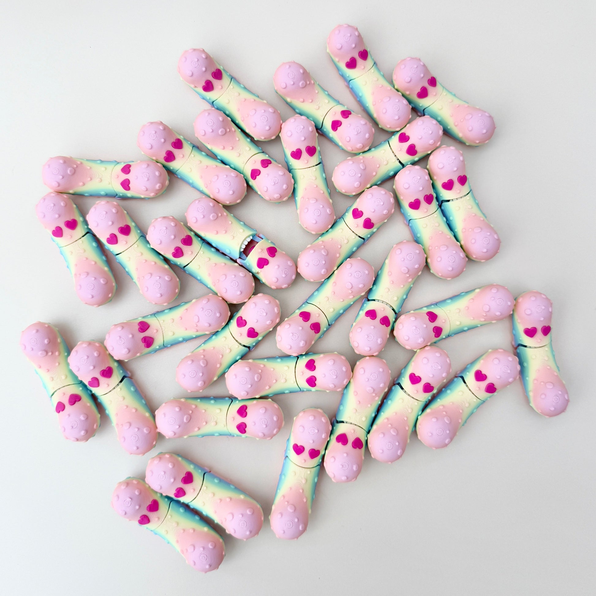 A shimmering rainbow fidget pickle with heart eyes, designed as a playful Valentine’s gift.