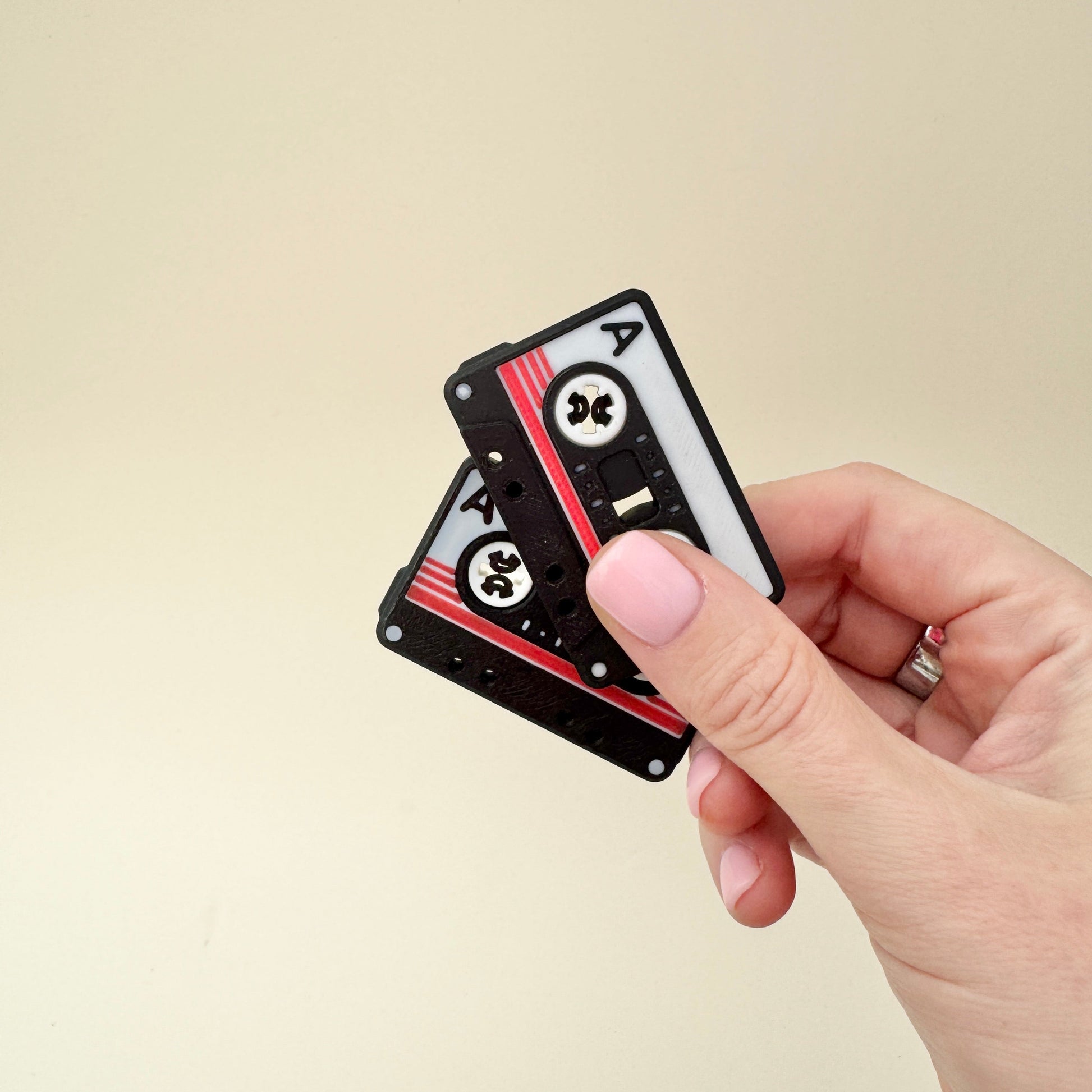 Small sensory desk toy for repeated thumb rolls
