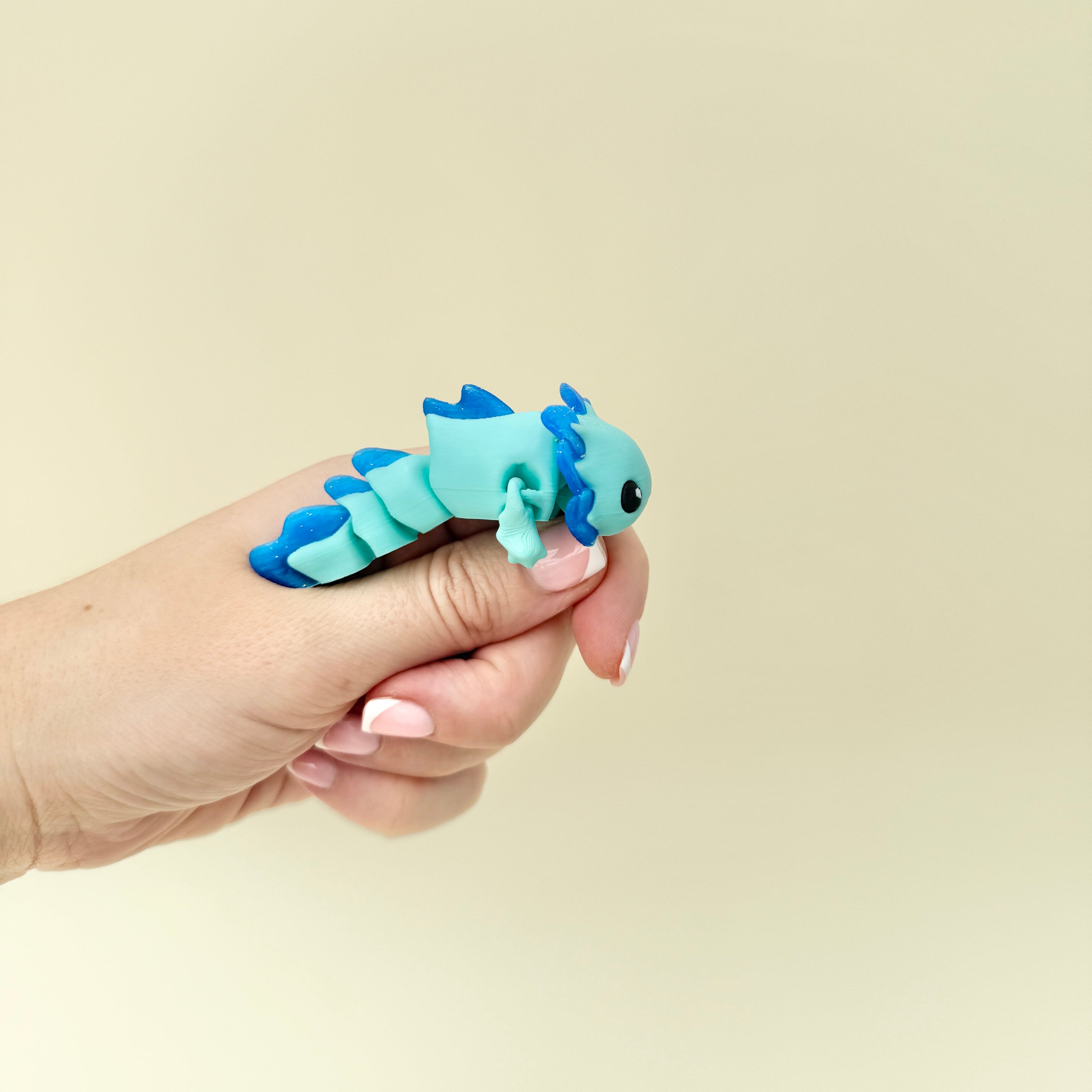 Light blue and glitter fidget dragon designed for tactile stimming, focus, and sensory regulation.