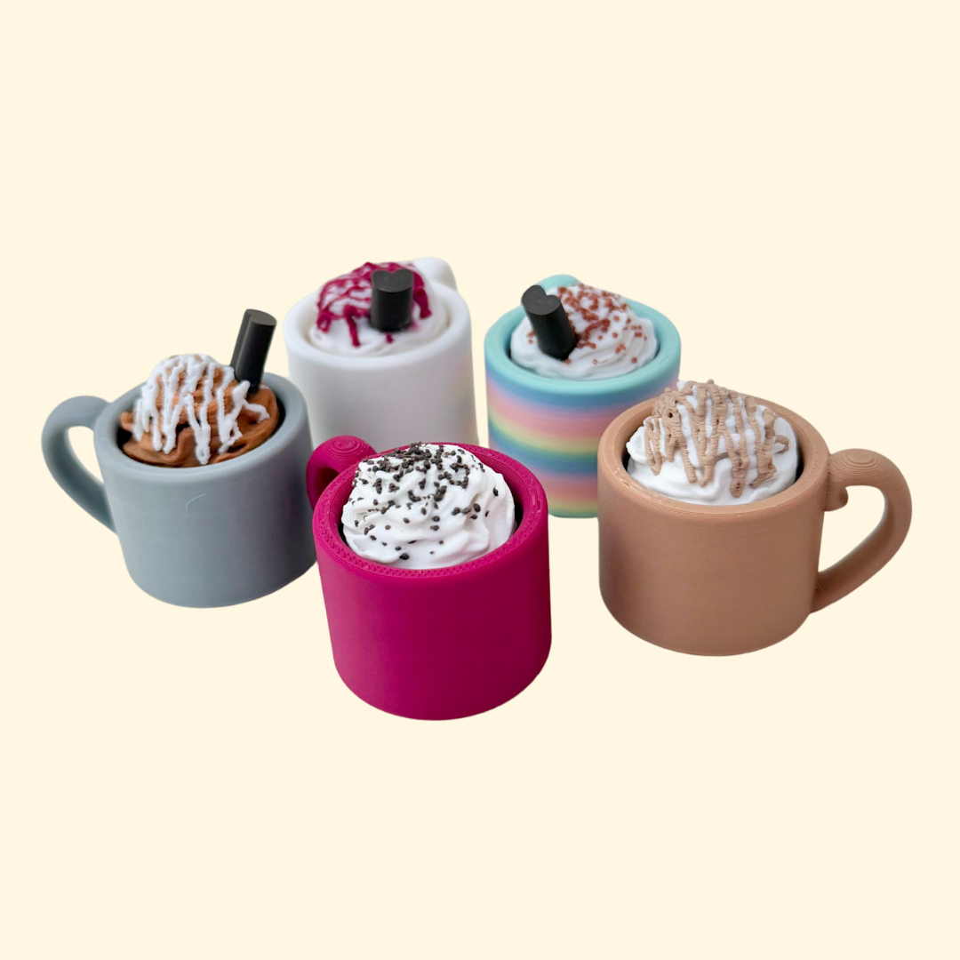 Mini mug-shaped clicker with textured whipped topping for sensory fidget use.
