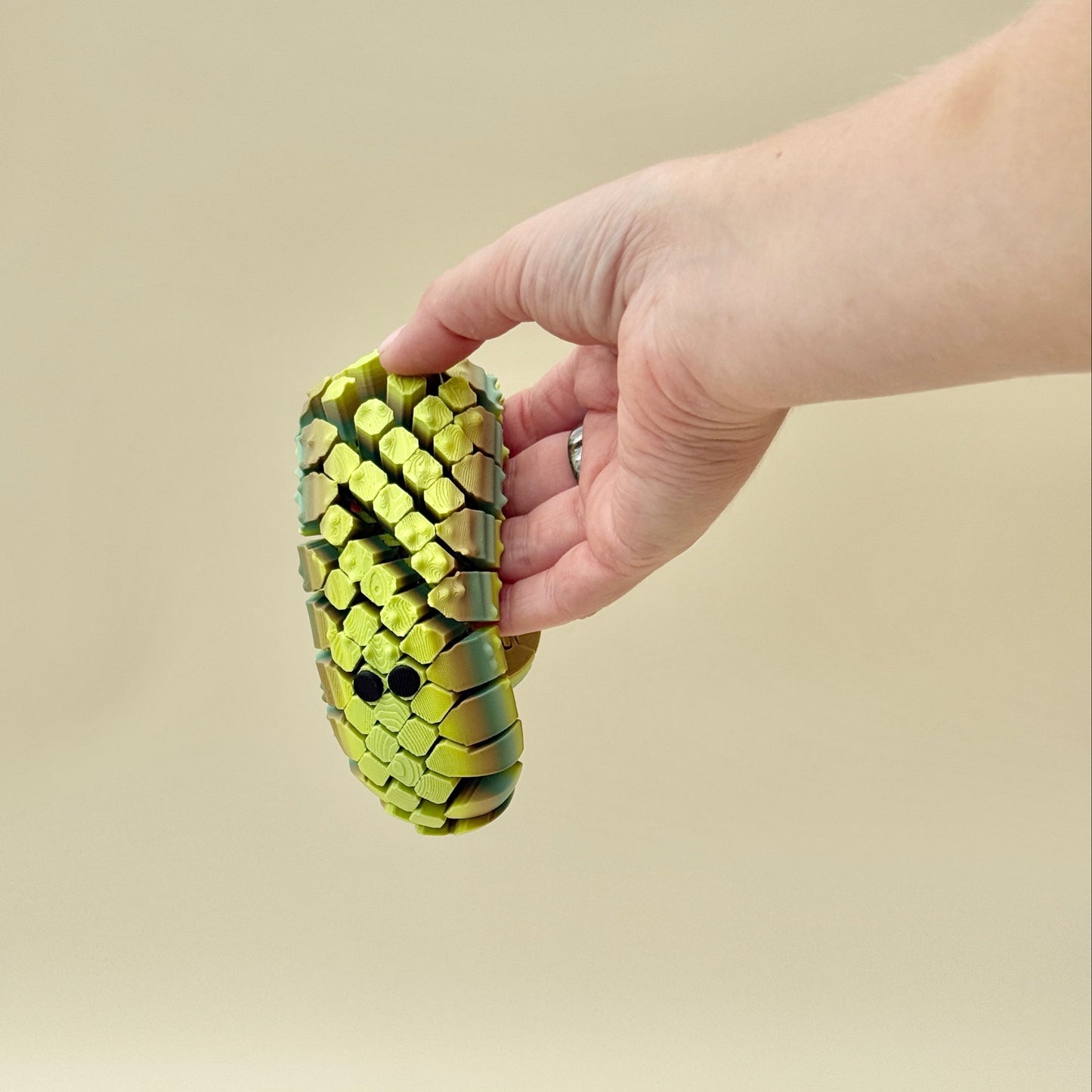 handheld net-style sensory fidget designed for smooth, repetitive motion
