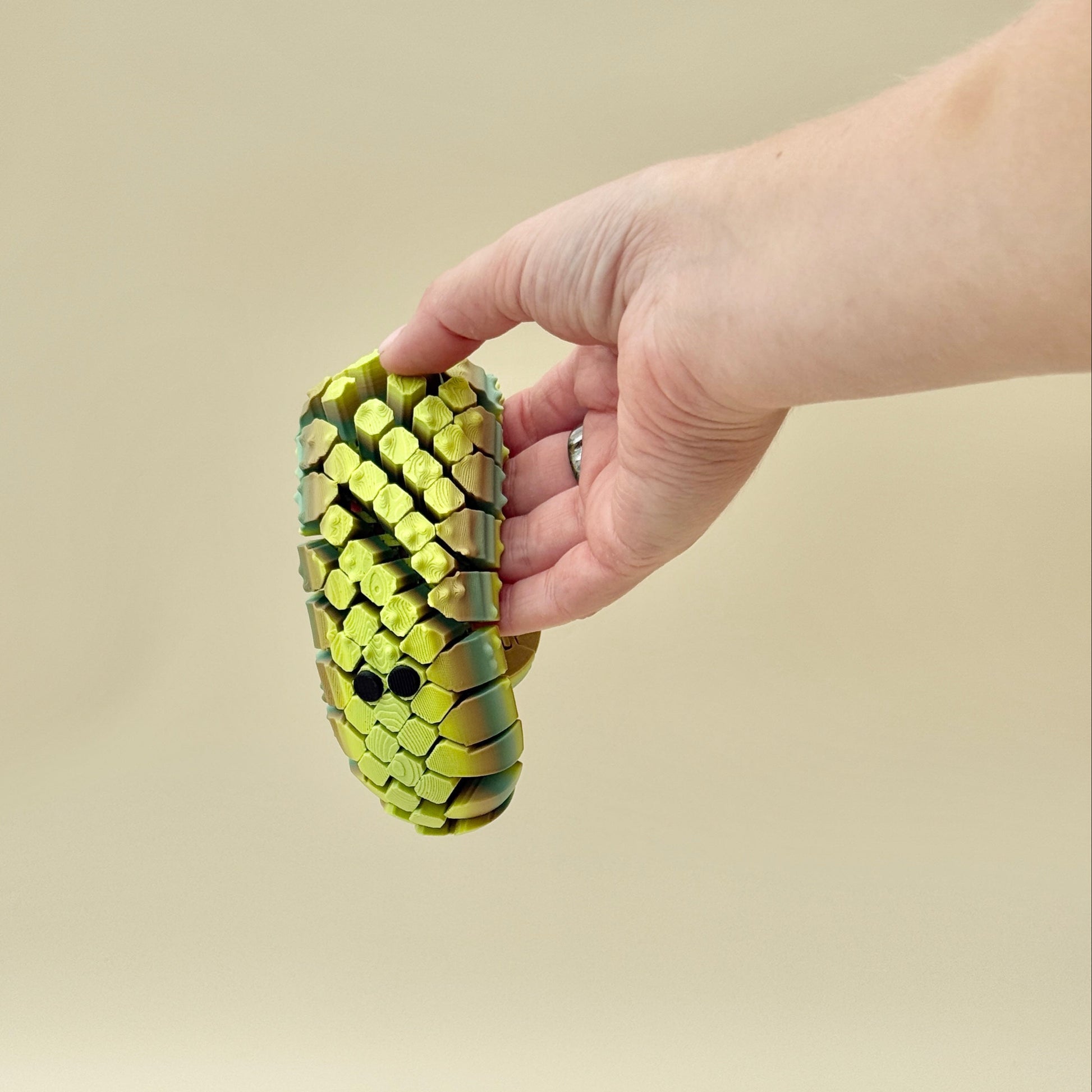 handheld net-style sensory fidget designed for smooth, repetitive motion
