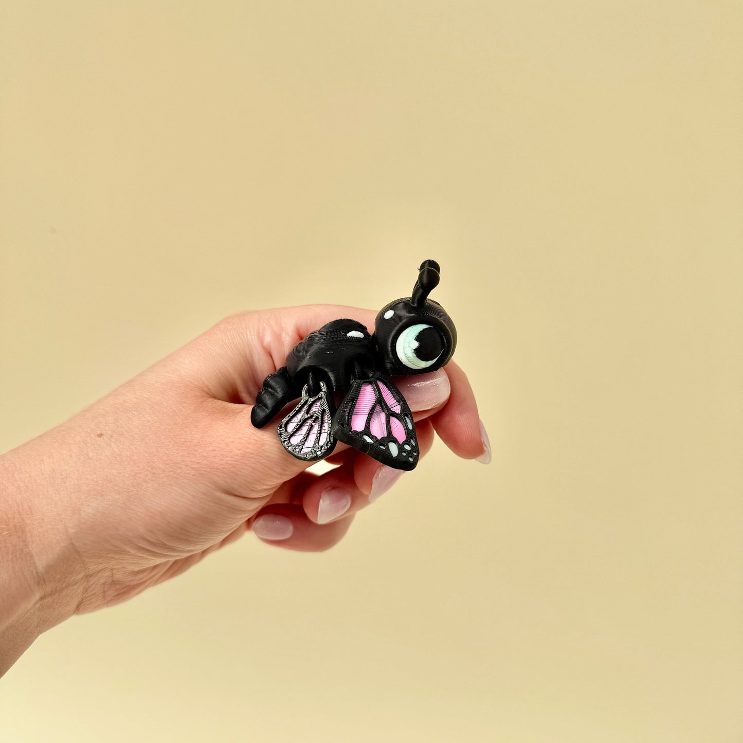 Articulated butterfly turtle toy with moving wings and big cartoon-style eyes