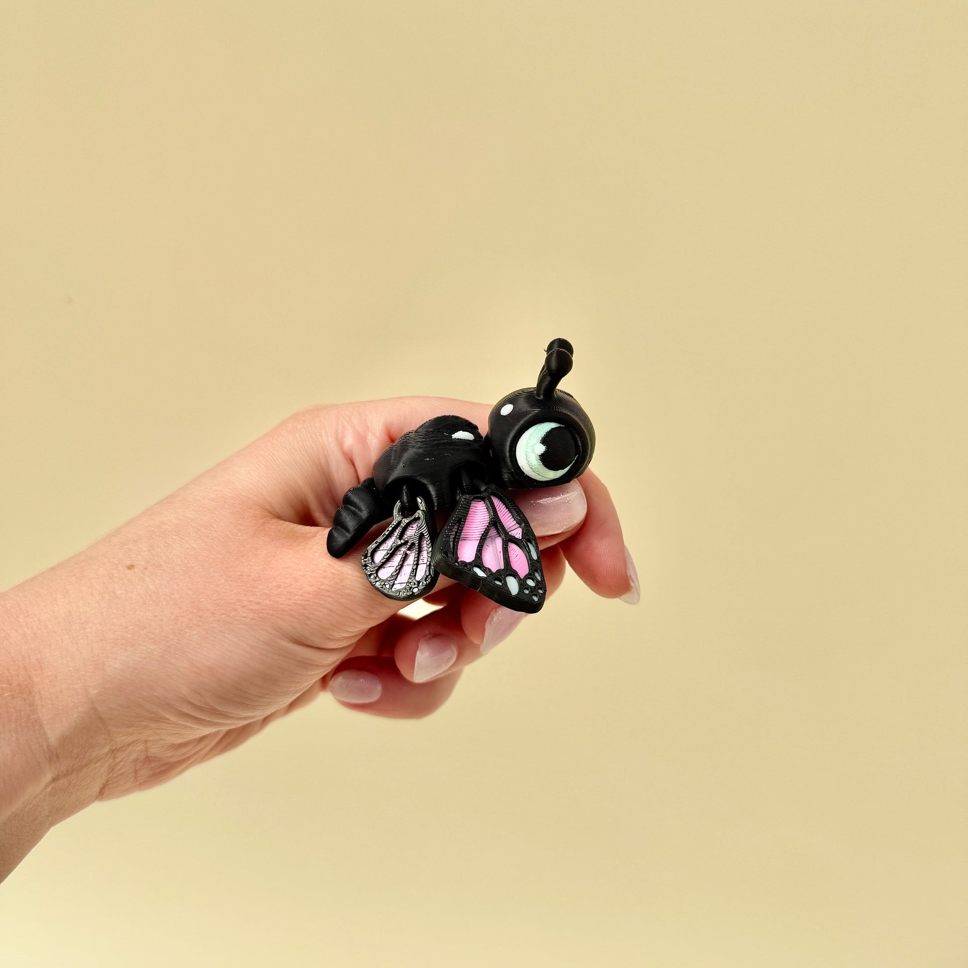 Articulated butterfly turtle toy with moving wings and big cartoon-style eyes