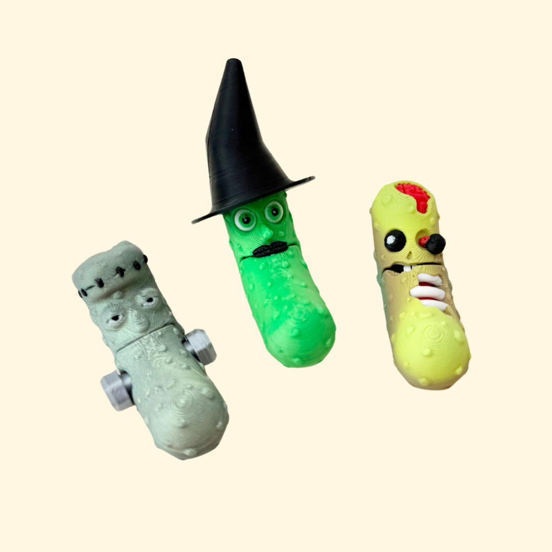 Halloween pickle fidget toy with witch hat and moustache, bumpy texture, mouth opens when wiggled, keyring-ready
