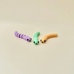 Worm fidget toy with a small apple container, a fun add-on option for play and portability.

