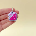 A 4cm lilac potion bottle-shaped keyring fidget toy with bright pink liquid and heart details.