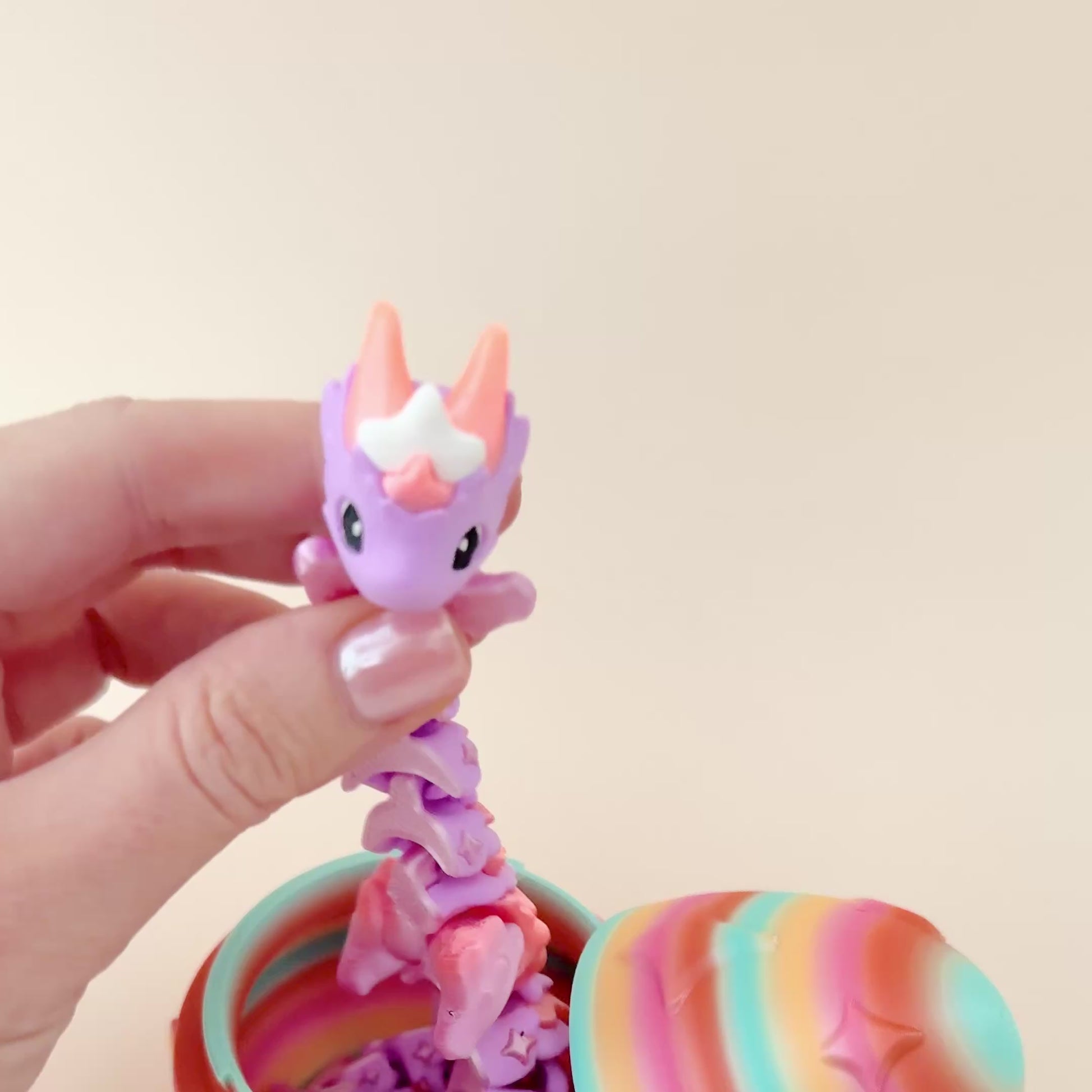 Stunning lilac and peach dragon paired with a colourful egg featuring twinkling star patterns, perfect for sensory play.
