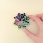 The ShapeShifters Star toy being moved to show its layered, cascading effect.