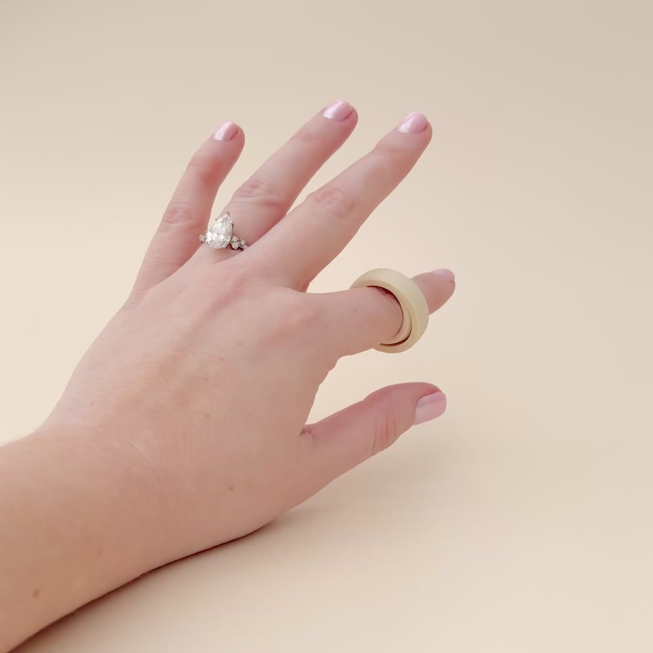 A demonstration video of the FidgiRing fidget toy being spun on a finger, showcasing its smooth movement and discreet design for stress relief and focus.