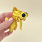 Elegant silk gold goldfish fidget toy featuring scale texture and moveable fins and tail.