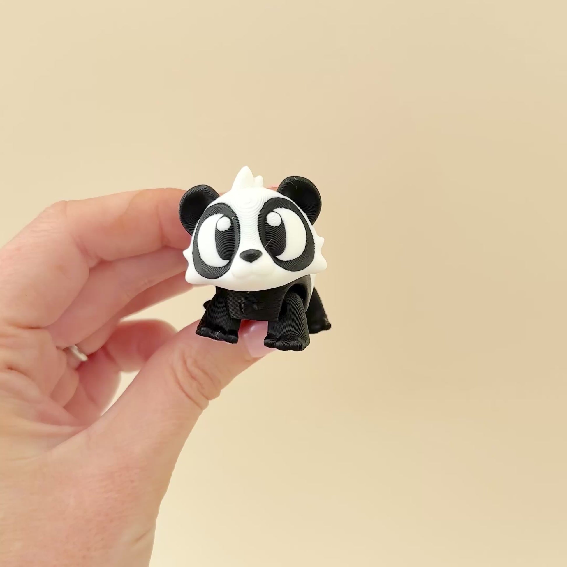A compact and adorable panda fidget toy that moves with ease, ideal for discreet sensory play.