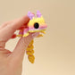 Fully articulated Skyburst Dragon fidget toy in sunrise tones with peach scales and lilac horns.