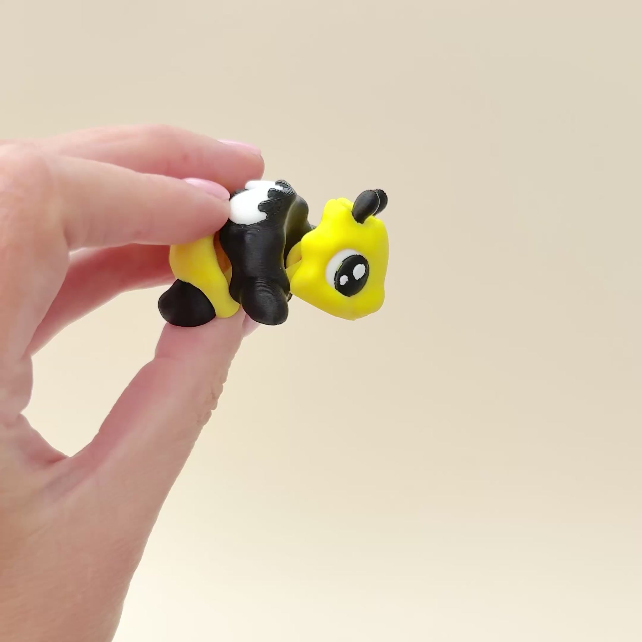 A charming, articulated bee fidget toy designed for sensory engagement and stress relief.
