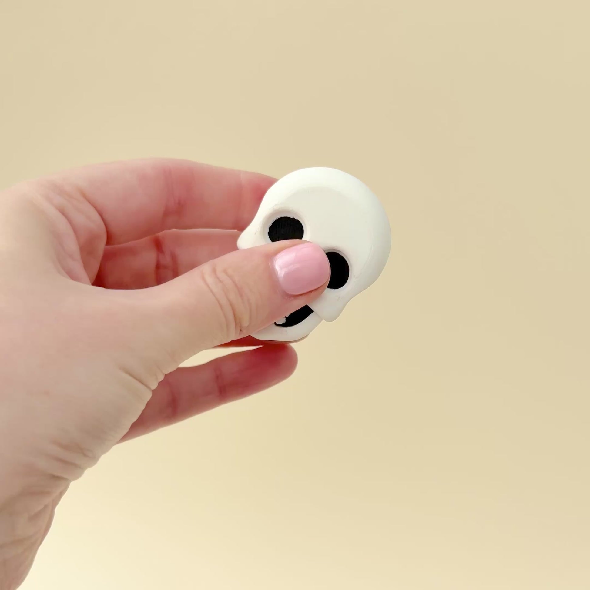Two magnetic fidget toys that feature a sugar skull on one side and a realistic skull on the other. Great for desk play or fridge decor.