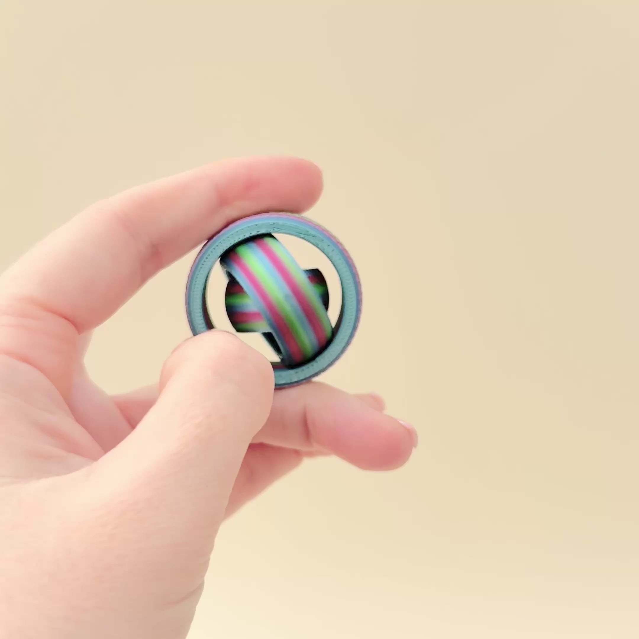 Petite fidget spinner featuring a full gyro spinning mechanism and colourful rainbow design.  Gyro Rainbow Fidget Spinner