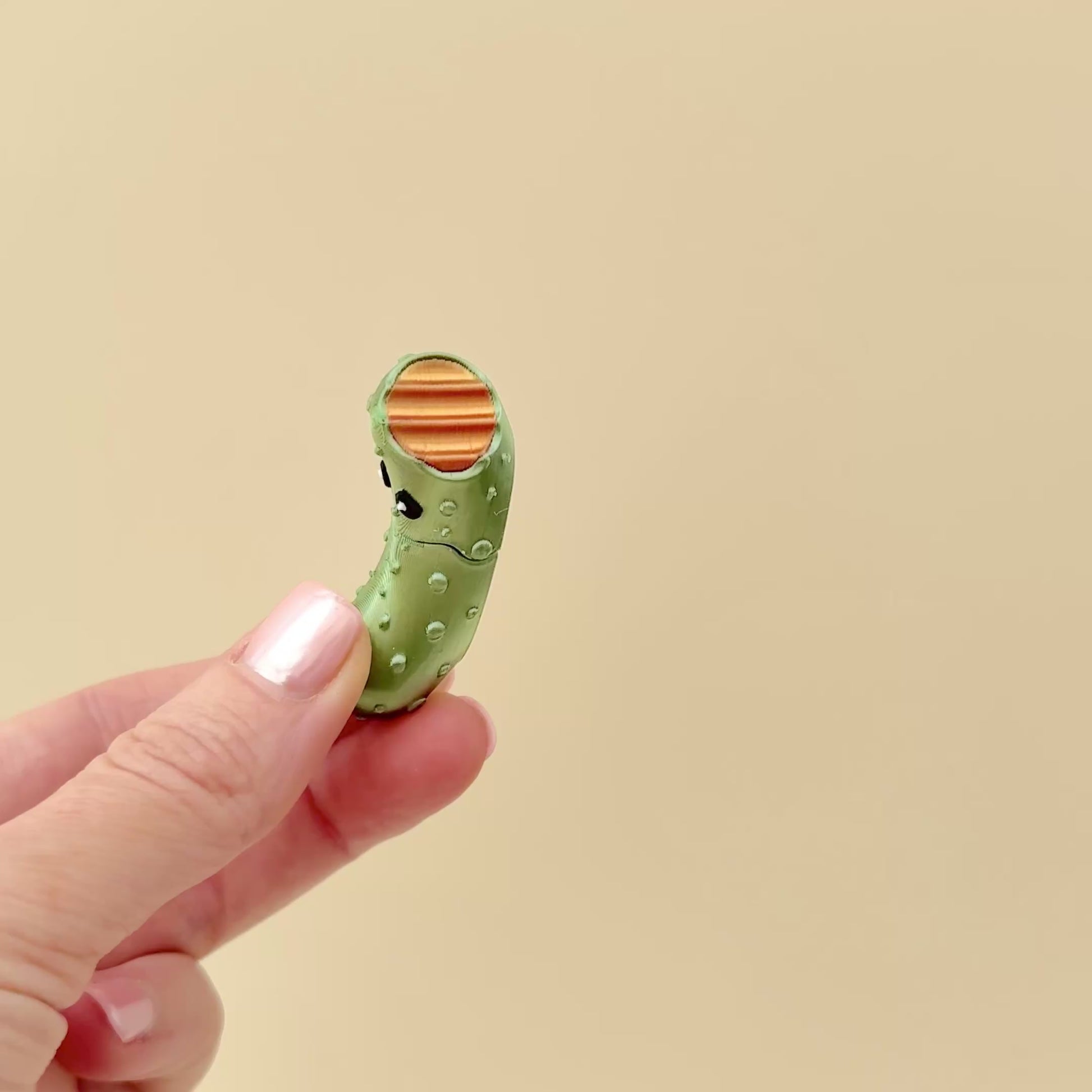 A compact fidget toy shaped like a pickle, easy to carry and perfect for on-the-go fidgeting.